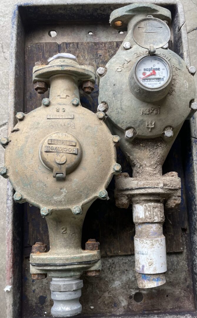 A close up of two valves on the side of a building.
