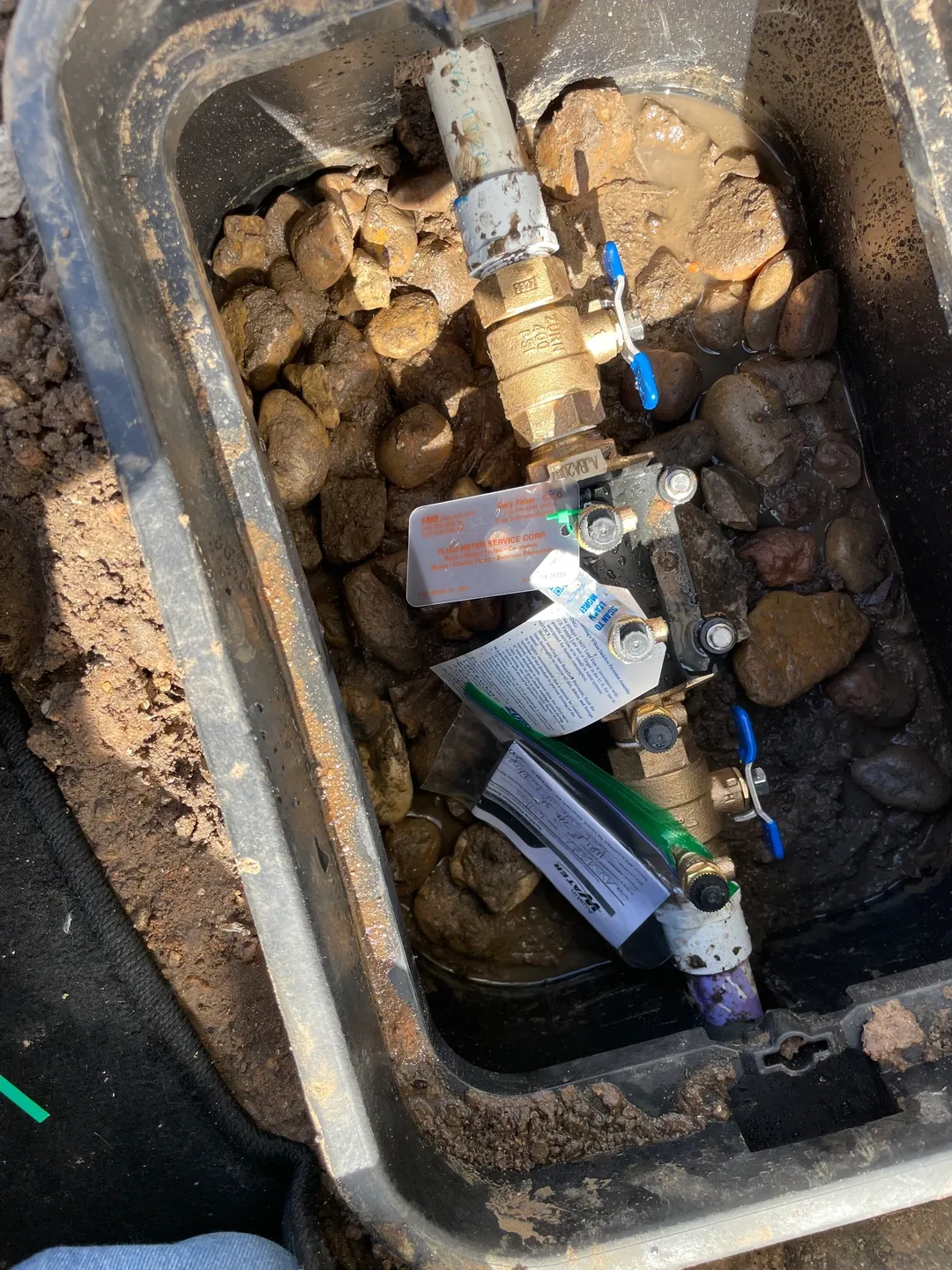 Professionals performing backflow testing for a client in Austin, TX.